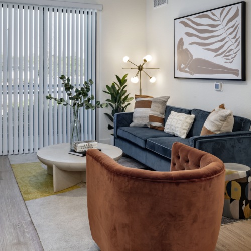 a living room with a chair, couch and a coffee table