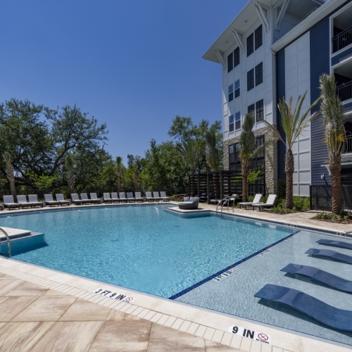 a swimming pool with lounge chairs